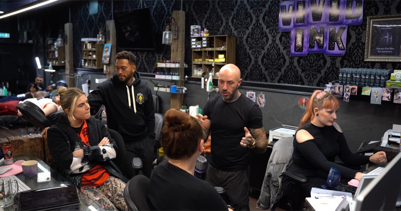 Andy in a Vivid Ink studio with the team