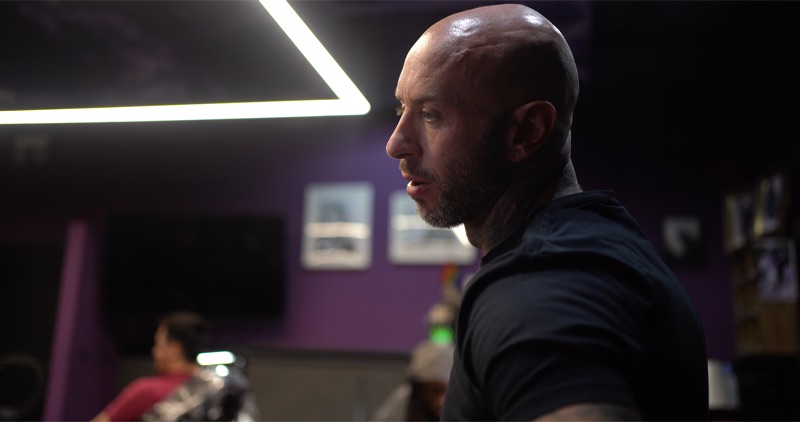 Andy in profile inside a Vivid Ink studio