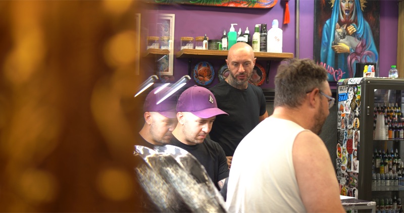 Andy in a busy Vivid Ink studio scene